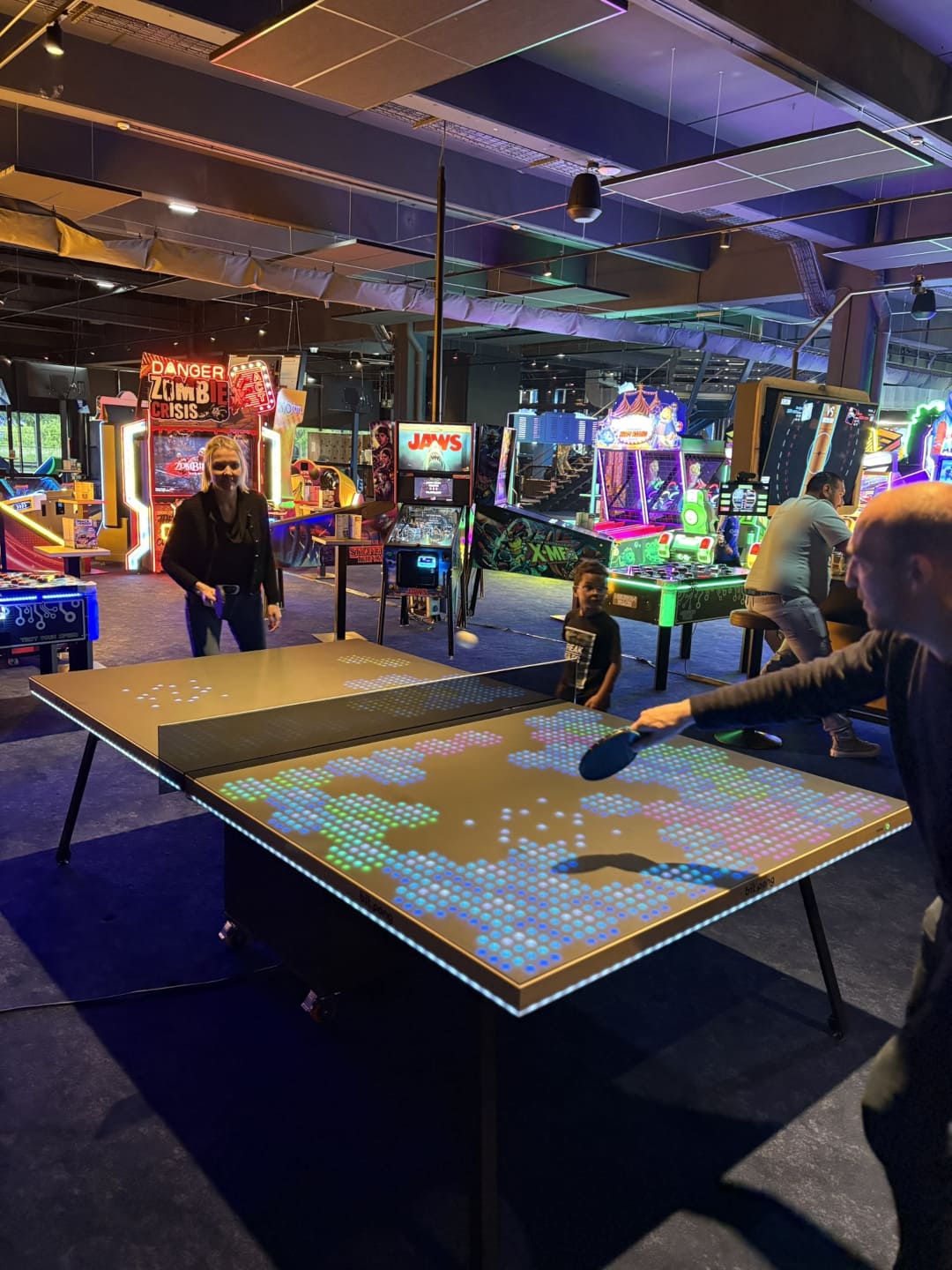 Two players on a digitally enhanced ping pong table